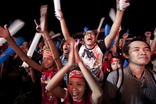 Supporters of Myanmar opposition leader Aung San Suu Kyis National League for Democracy party cheer as they watch the results of the general election on an LED screen displayed outside the partys headquarters Monday Nov. 9 2015 in Yangon Myanmar. My