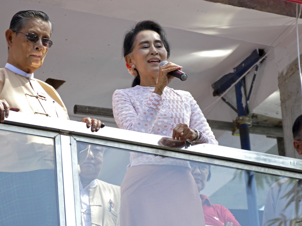 Supporters of Myanmar opposition leader Aung San Suu Kyi's party cheer as they watch the first official results on a giant screen outside the party headquarters in Yangon