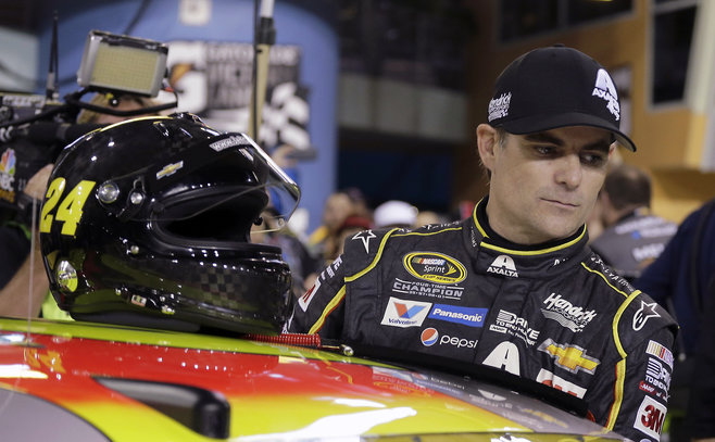 Jeff Gordon prepares to get into his car before qualifying for the NASCAR Sprint Cup Series auto race Friday Nov. 20 2015 at Homestead Miami Speedway in Homestead Fla