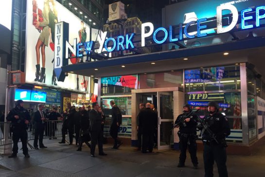 Police officers stand guard in Times Square Wednesday Nov. 18 2015 in New York. The New York Police Department says it's aware of a newly released Islamic State group video showing images of Times Square but says there's no current or specific threat