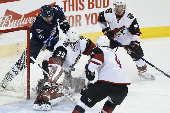 Anders Lindback saves the shot by Winnipeg Jets Blake Wheeler as Coyotes Zbynek Michalek and Klas Dahlbeck defend during the first period of an NHL hockey game in Winnipeg Manitoba on Saturday Nov