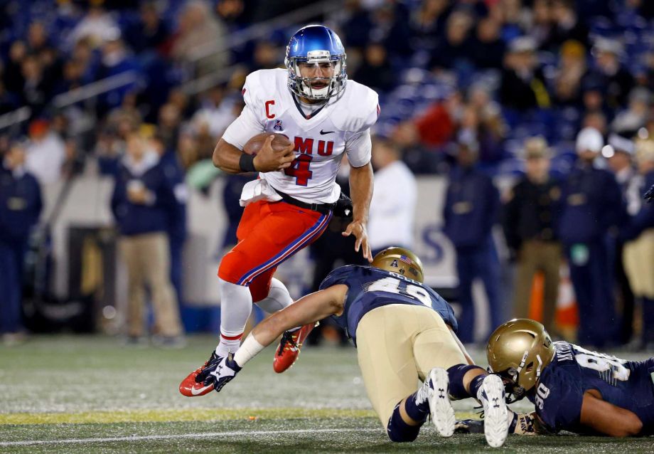 SMU quarterback Matt Davis center jumps over Navy linebacker Mike Kelly as he rushes the ball in the second half of an NCAA college football game Saturday Nov. 14 2015 in Annapolis Md. Navy won 55-14