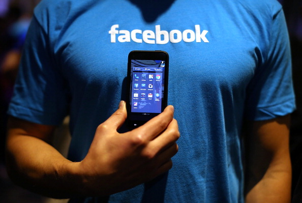 A Facebook employee holds a phone that is running the new 'Home&#039 program during an event at Facebook headquarters