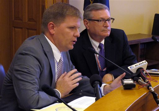 Shawn Sullivan left Kansas Gov. Sam Brownback's budget director answers questions from reporters about adjustments to the state's budget to avert a deficit following a new more pessimistic forecast for revenue collections Friday Nov. 6 20