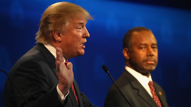 Presidential candidate Donald Trump speaks while Ben Carson looks on during the CNBC Republican presidential debate in Boulder Colorado