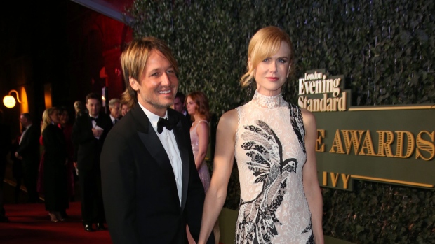 Nicole Kidman right poses with her husband Keith Urban upon arrival at the Evening Standard Theatre Awards in London on Sunday