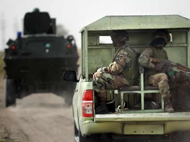 Nigerian soldiers patrol in the north of Borno state close to a former Boko Haram camp