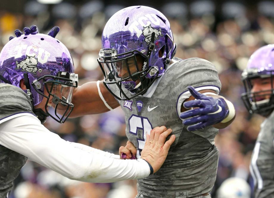 TCU quarterback Foster Sawyer left and running back Shaun Nixon celebrate Nixon's touchdown catch against Kansas in the fourth quarter of an NCAA college football game in Fort Worth Texas. Oklahom