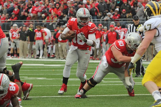 Then-redshirt freshman quarterback J.T. Barrett runs with the ball during a game against Michigan on Nov. 29 at Ohio Stadium. OSU won 42-28. Credit Lantern File