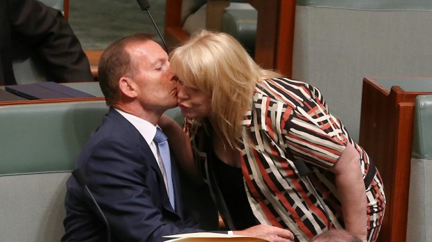 Former prime minister Tony Abbott is greeted by colleague Natasha Griggs as they take their seats on the backbench for question time last month