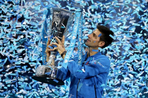 Novak Djokovic celebrates with the trophy after winning the Barclays ATP World Tour Finals