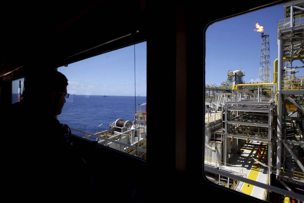 2010 an oil worker looks out over the Petrobras offshore ship platform over Tupi field in Santos Bay off the coast of Rio de Janeiro Brazil