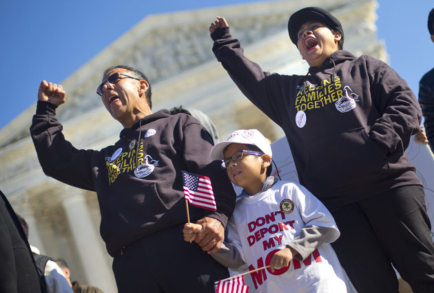 Six-year-old Michael Claros joins his parents at a rally in Washington on the anniversary of the announcement of President Obama's stalled executive actions on deportation relief