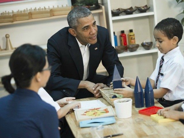 Barack Obama speaks with children between the ages of seven and nine as he tours the Dignity for Children Foundation in Kuala Lumpur