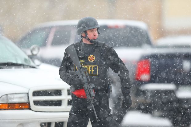 A member of the Colorado Springs sheriff's department secures the scene during an active shooter situation near a Planned Parenthood facility where an unidentified suspect has reportedly injured up to nine people including at least four police office