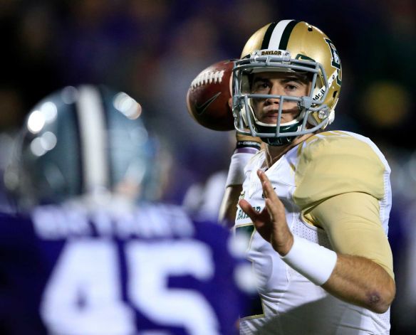 Baylor quarterback Jarrett Stidham right passes to a teammate over Kansas State defensive end Marquel Bryant during the second half of an NCAA college football game in Manhattan Kan. Thursday Nov. 5 2015. Baylor defeated Kansas State 31-24. Pho