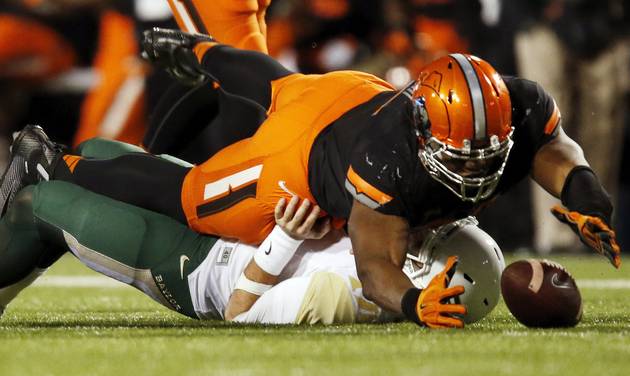 Emmanuel Ogbah recovers a rumble by Baylor's Jarrett Stidham in the second quarter during a college football game between the Oklahoma State University Cowboys and the Baylor Bears at Boone Pickens Stadium in Stillw