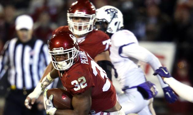 Perine breaks tackles on his way to a 72 yard touchdown run during the second half of a college football game where the University of Oklahoma Sooners defeated the TCU Horned Frogs 30-29 at Gaylord Family Oklahoma Memor