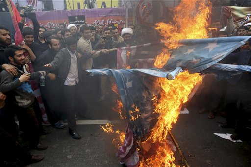 Iranian demonstrators burn representations of the U.S. flag during an annual rally in front of the former U.S. Embassy in Tehran marking 36th anniversary of the seizure of the embassy by militant Iranian students Iran Wednesday Oct. 4 2015. The annua