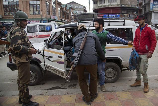 Polioe firsk a man at a temporary checkpoint in Srinagar on Wednesday