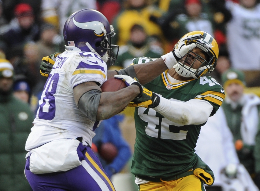 Nov 24 2013 Green Bay WI USA Minnesota Vikings running back Adrian Peterson stiff arms Green Bay Packers safety Morgan Burnett in the 4th quarter at Lambeau Field. Benny Sieu-USA TODAY Sports