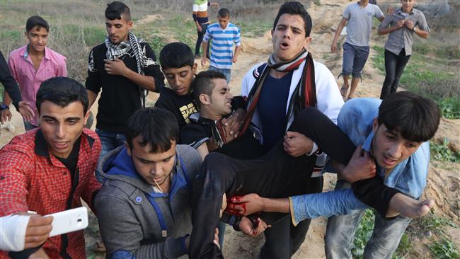 Palestinians carry an injured protester during clashes with Israeli military forces in the eastern suburbs of Gaza City