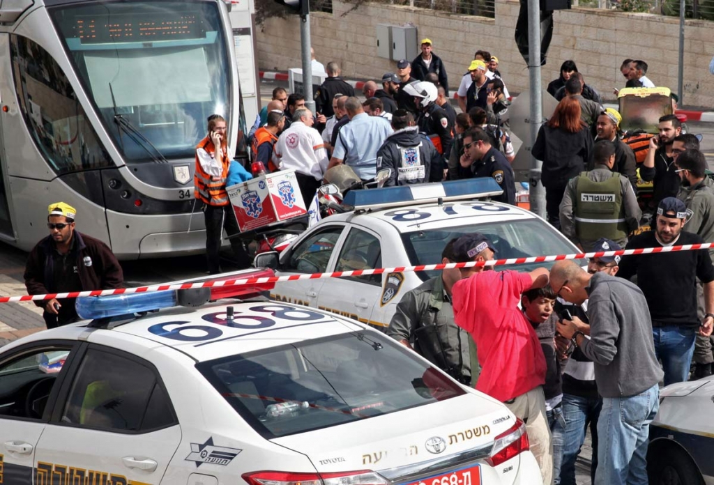 Israeli police officers detain a Palestinian boy suspected in a stabbing attack in a light rail train in Jerusalem Tuesday Nov. 10 2015