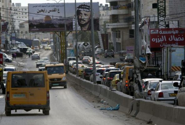 Palestinians drive near the Qalandia checkpoint between Jerusalem and Ramallah Nov. 10 2015