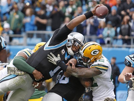 Carolina Panthers Cam Newton reaches the ball over the goal line for a touchdown against the Green Bay Packers in the first half of an NFL football game in Charlotte N.C. Sunday Nov. 8 2015