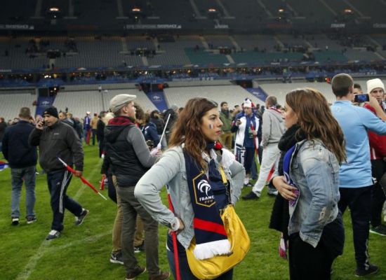 French supporters invade the pitch of the Stade