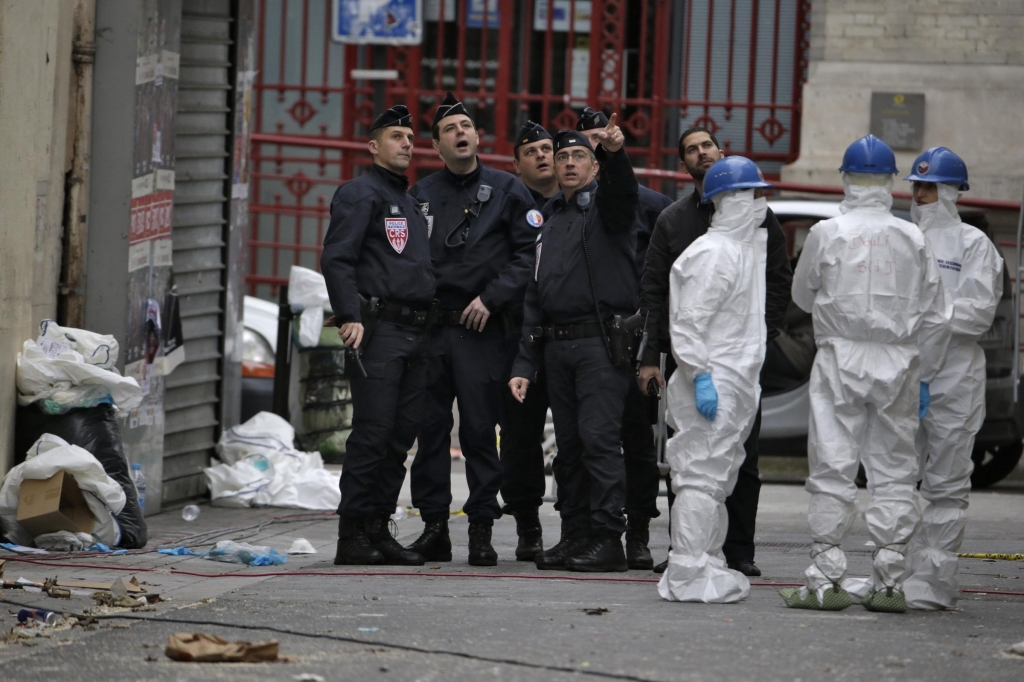 Forensics of the French police are at work outside a building in the northern Paris suburb of Saint-Denis on Thursday where French Police special forces raided an apartment the day before