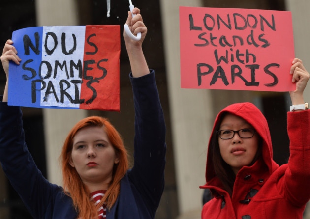 Two of the people at a vigil in Trafalgar Square this afternoon hold placards saying