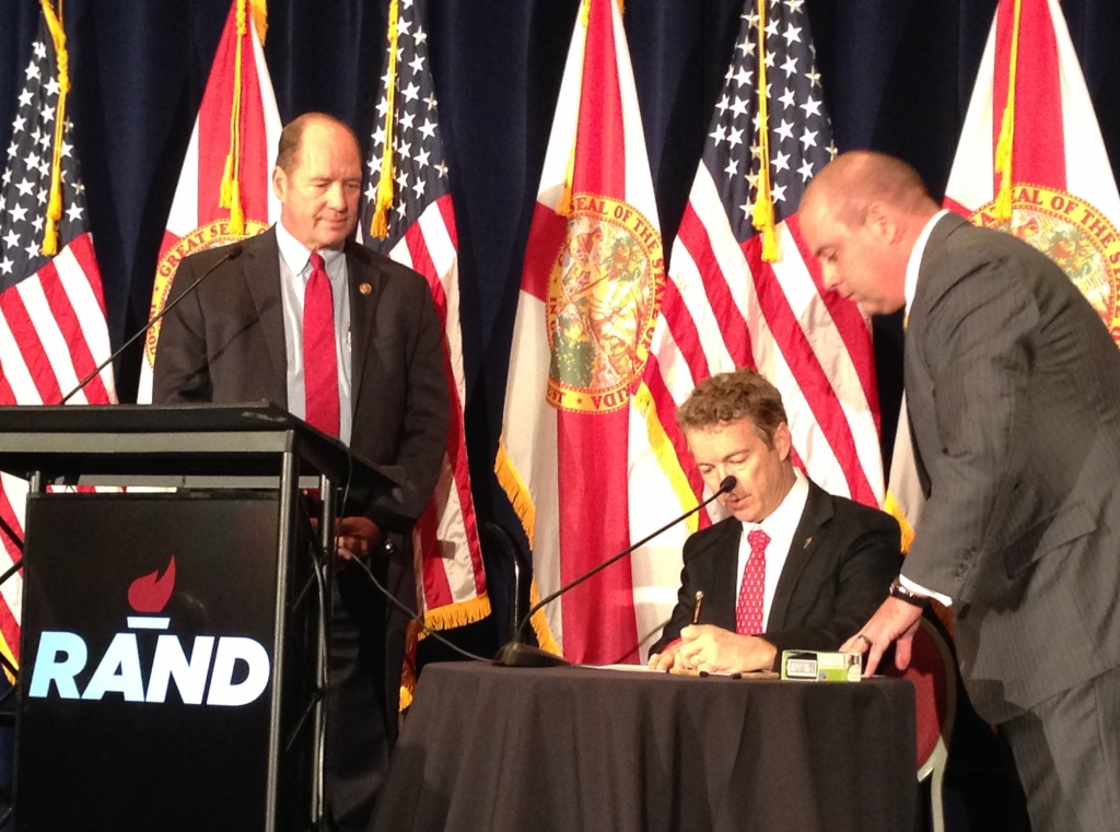 Rand Paul signs papers to get on the Florida presidential primary ballot as Rep. Ted Yoho and Republican Party of Florida Chairman Blaise Ingoglia look