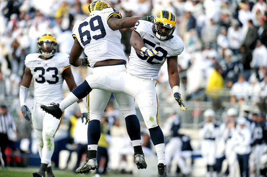 Royce Jenkins Stone #52 of the Michigan Wolverines celebrates with Willie Henry #69 after a sack in the fourth quarter against the Penn State Nittany Lions at Beaver Stadium