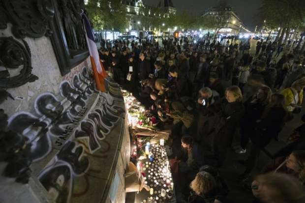 People light candles at a makeshift memorial at the Place de la Republique in Paris