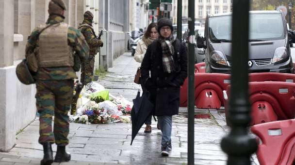 People light candles in front of the Cosa Nostra restaurant honouring victims of the deadliest attacks on France in decades