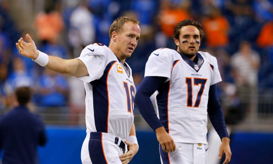 Denver Broncos quarterbacks Peyton Manning and Brock Osweiler get ready for the Broncos NFL football game against the Detroit Lions in Detroit. Osweiler gets his first NFL start in his fourth pro seaso