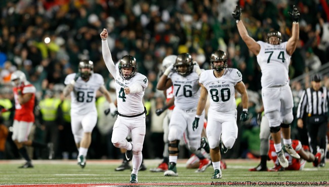 Michigan State kicker Michael Geiger runs down the field in celebration after kicking the game-winning 41-yard field goal against Ohio State as time expired in the fourth quarter of an NCAA college football game Saturday Nov. 21 2015 in Columbus O