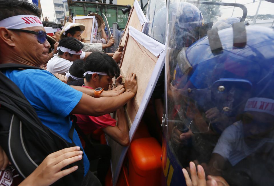 The Latest Protestors jostle with police burn mock US flag