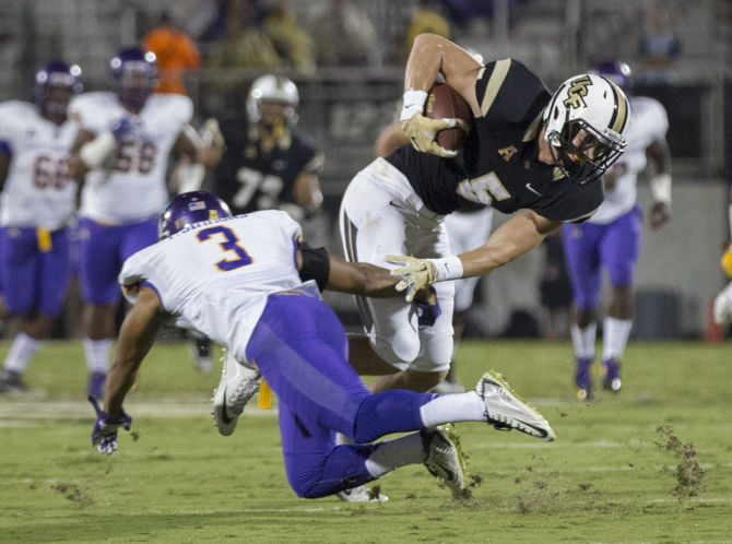 Central Florida wide receiver Jordan Franks almost slips past East East Carolina defensive back Travon Simmons during the first half of an NCAA college football game Thursday Nov. 19 2015 in Orlando Fla. CFP114