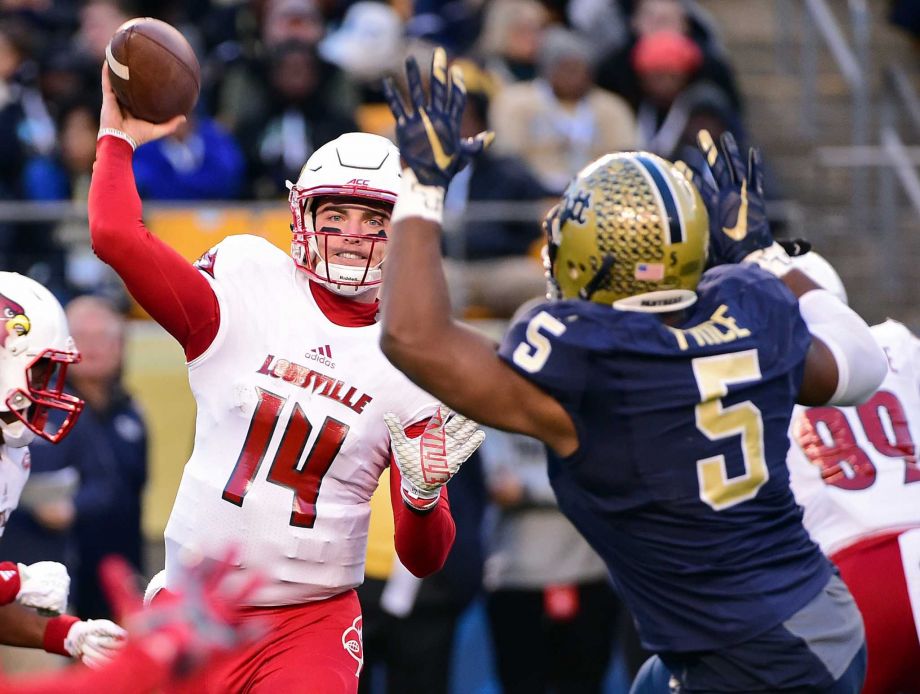 Louisville quarterback Kyle Bolin throws a pass as Pittsburgh defensive lineman Ejuan Price defends during the first half of an NCAA college football game Saturday Nov. 21 2015 in Pittsburgh