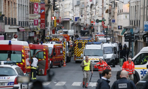 Police and Ambulance vans are parked in the Saint Denis area of Paris after a flat was raided by French police in the wake of the terro