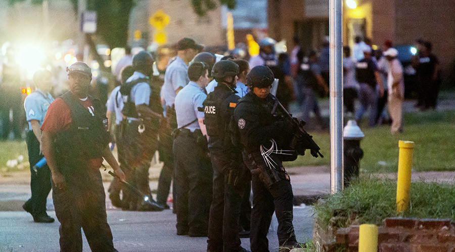 Police line up to block the street as protesters gathered after a shooting incident in St. Louis Missouri