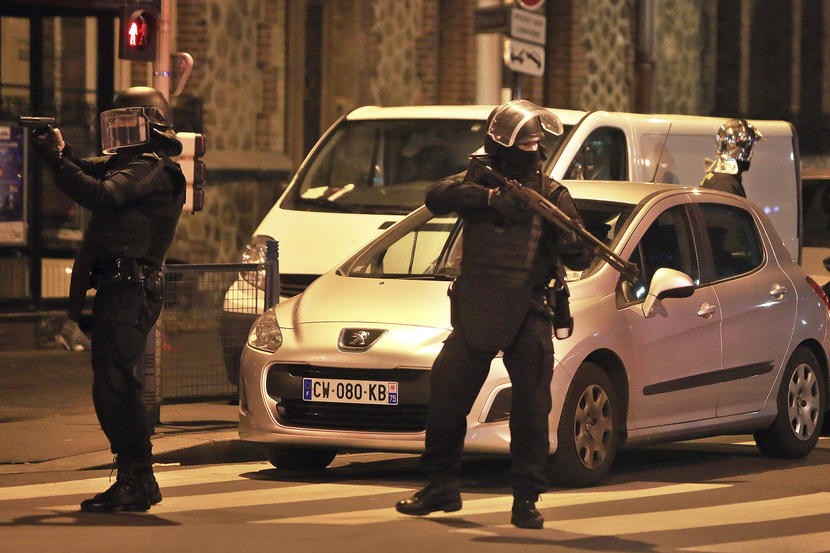 Police officers take up positions in Saint Denis a northern suburb of Paris Nov. 18 2015