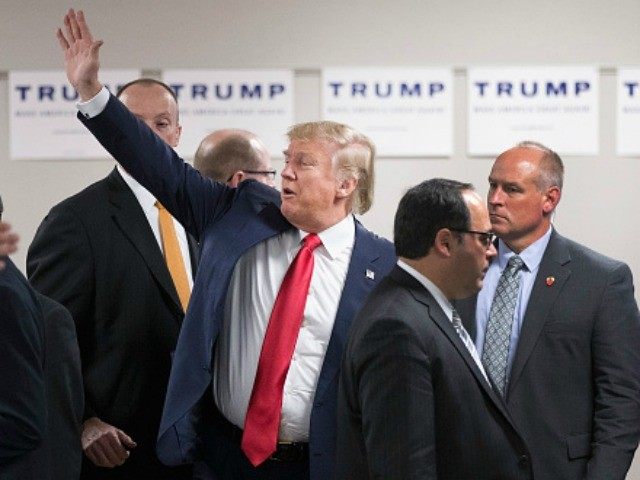 Republican presidential candidate Donald Trump waves to guests as he leaves a rally at Des Moines Area Community College Newton Campus