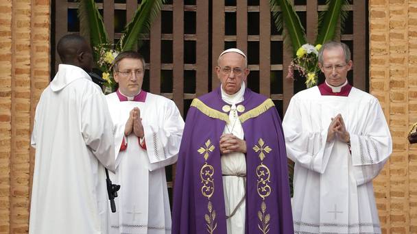 Pope Francis stops in prayer before opening the holy door of the Bangui cathedral