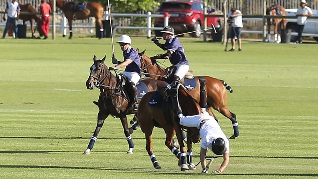 Prince Harry filmed tumbling off horse at charity polo match