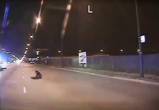 In this Oct. 20 2014 frame from dash-cam video provided by Chicago Police Department Laquan Mc Donald falls to the ground after being shot by officer Jason Van Dyke in Chicago. Van Dyke who shot Mc Donald 16 times was charged with first-degree murder Tu