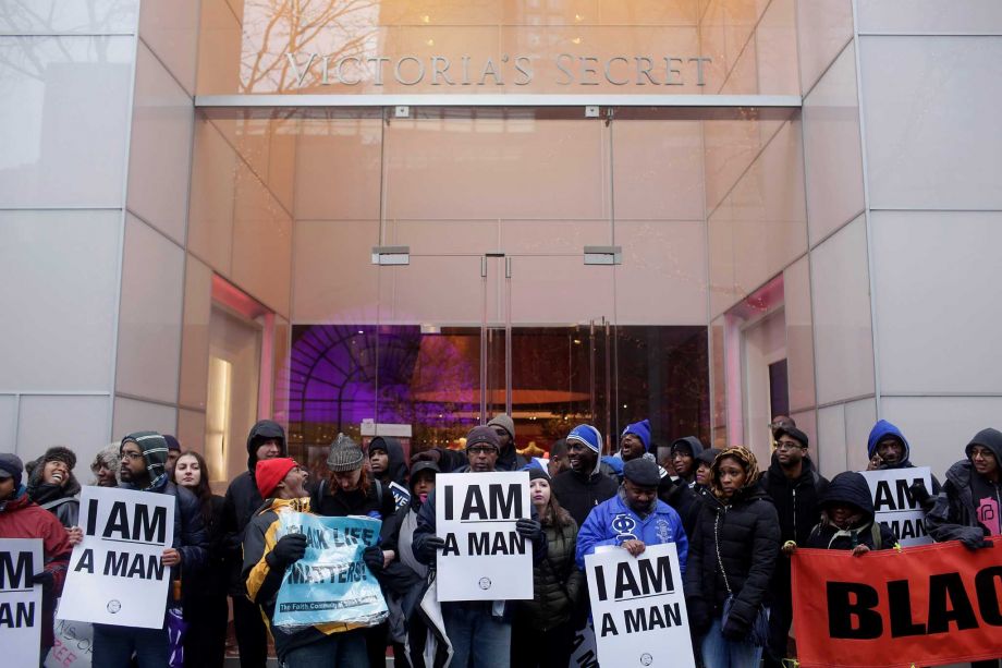 Demonstrators block the entrance to Victoria's Secret as they protest the shooting of Laquan Mc Donald who was killed by a Chicago police officer in Oct. 2014 Friday along Michigan Avenue