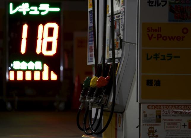 Pumps are seen next to a petrol price board at a Showa Shell Sekiyu gas station in Tokyo Japan